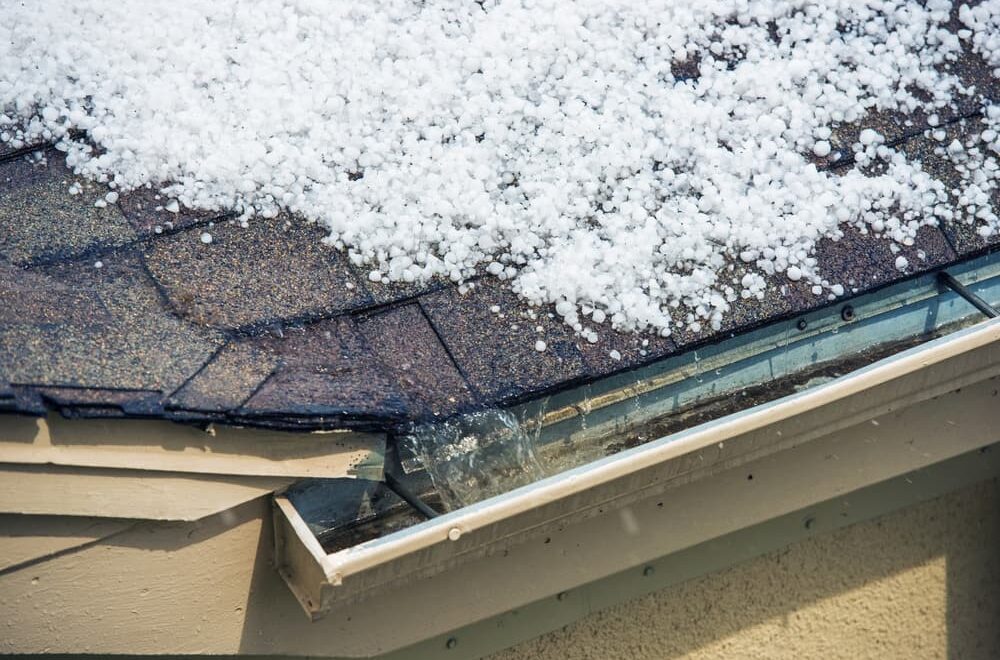 Melting hail accumulates on the roof, illustrating the impact of severe weather.