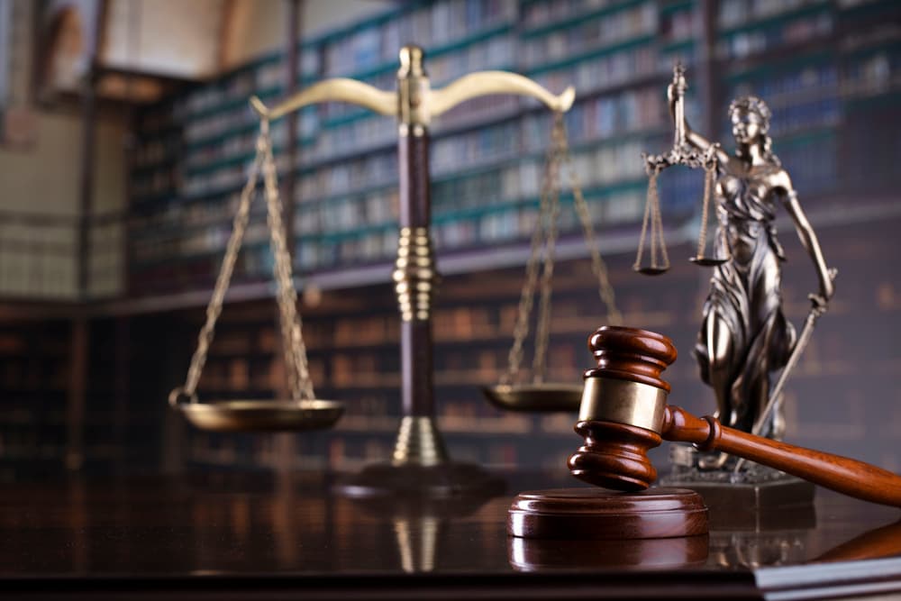 The image of a judge's gavel with a library background, symbolizing law and justice.