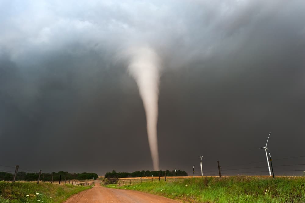 A beautifully defined tornado stretches across the American Plains, showcasing its powerful and majestic funnel shape against a dramatic sky.






