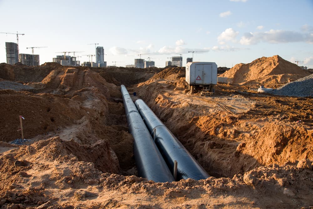 Cast iron sewer pipes for installing an external sewage system at a construction site, designed for the sanitary drainage of a multi-story building.






