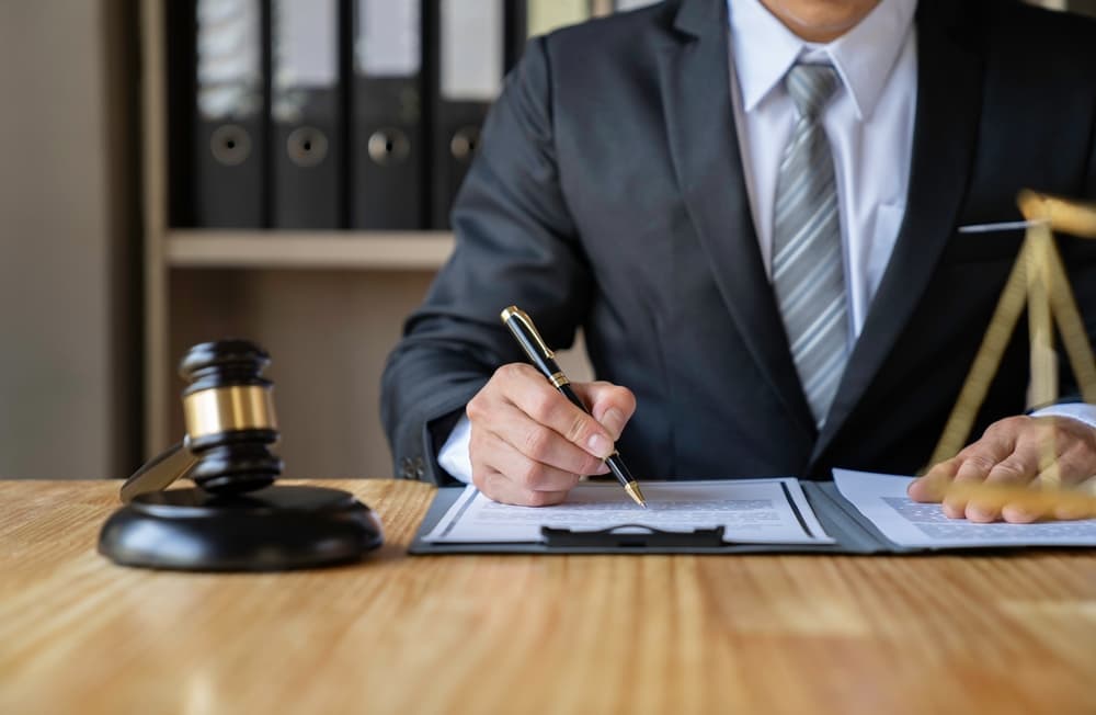 Attorney or businessman reading law book in office, consulting on legal matters.






